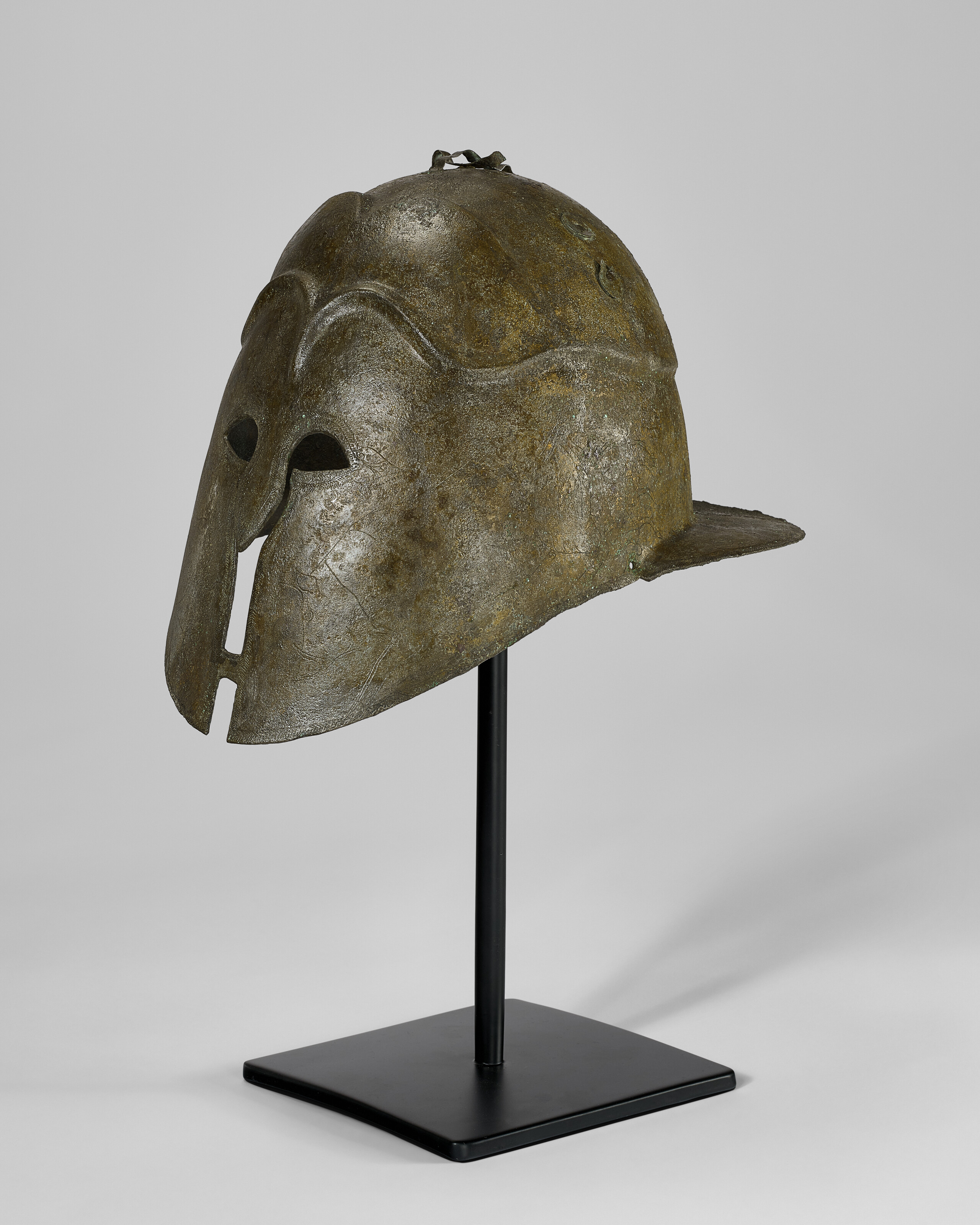 A GREEK BRONZE APULO-CORINTHIAN HELMET, MAGNA GRAECIA, LATE