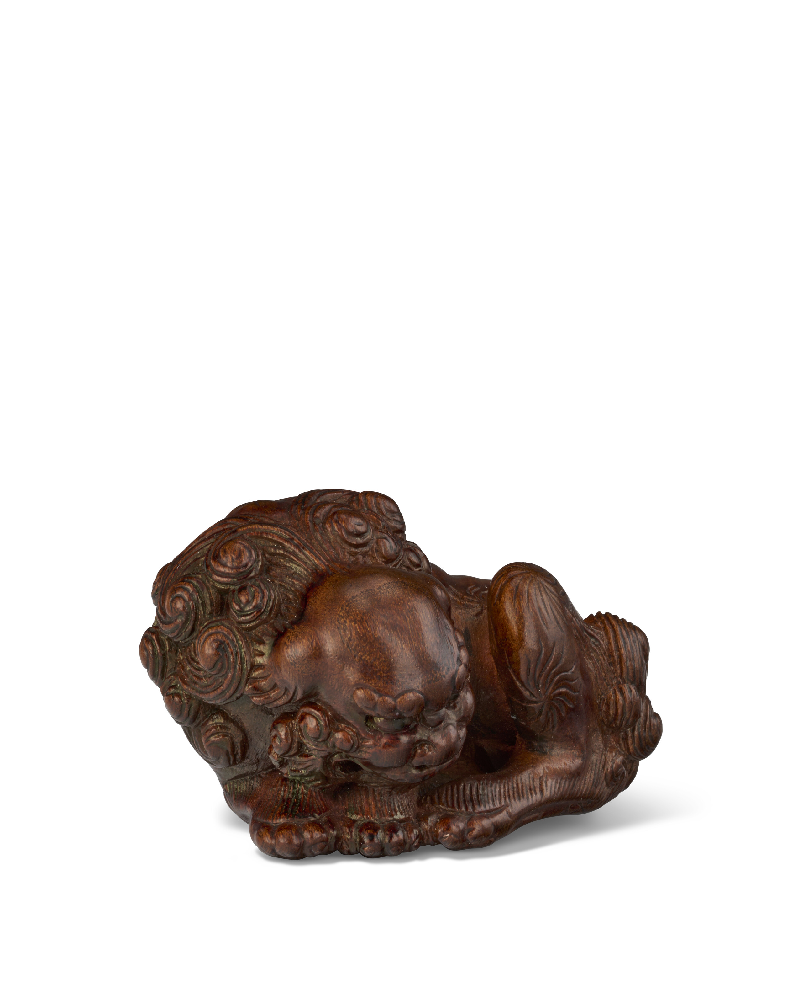 A WOOD NETSUKE OF A SHISHI CURLING UP, JAPAN, EDO PERIOD (19TH