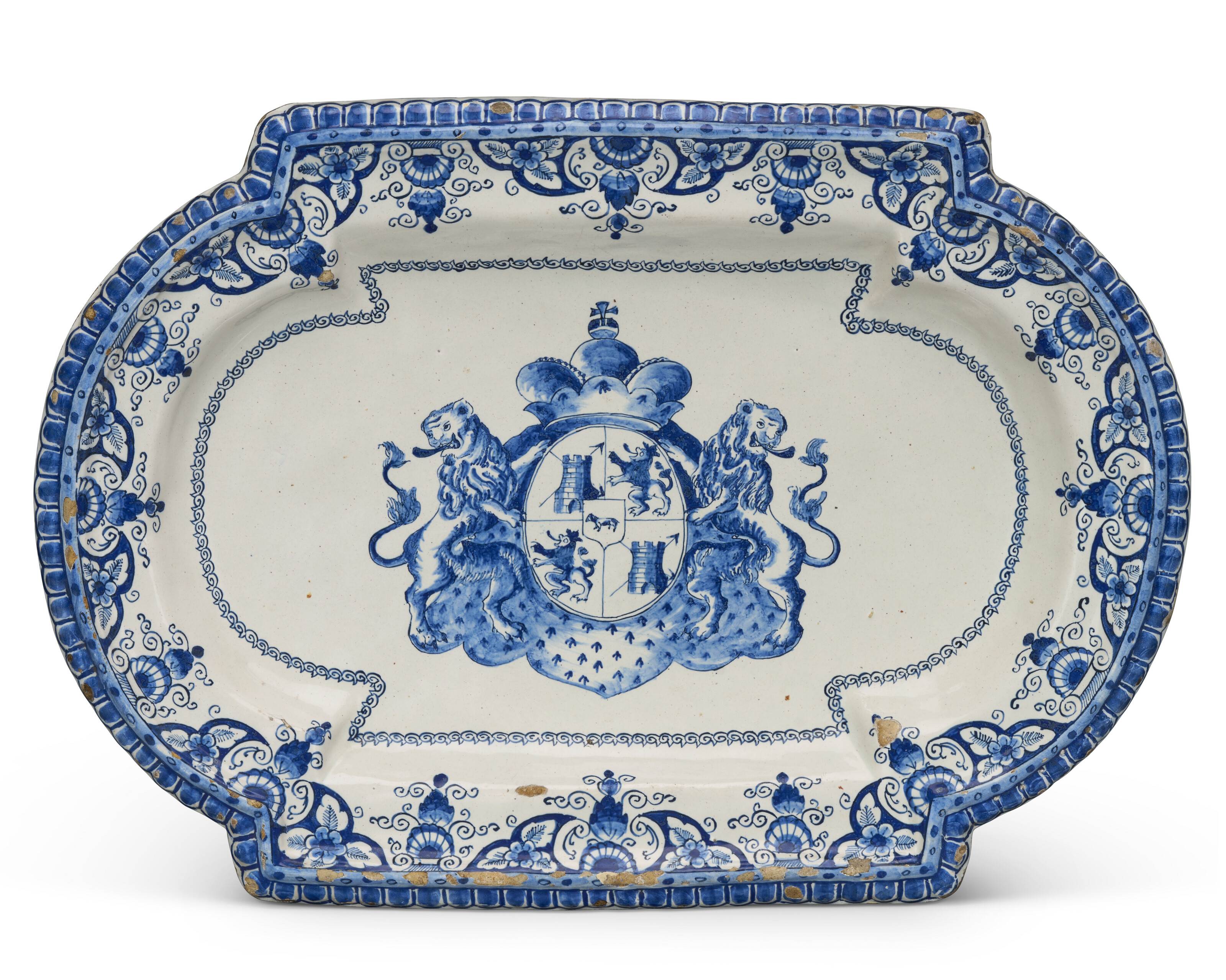 A DUTCH DELFT BLUE AND WHITE ARMORIAL SHAPED PLATTER, CIRCA 1691