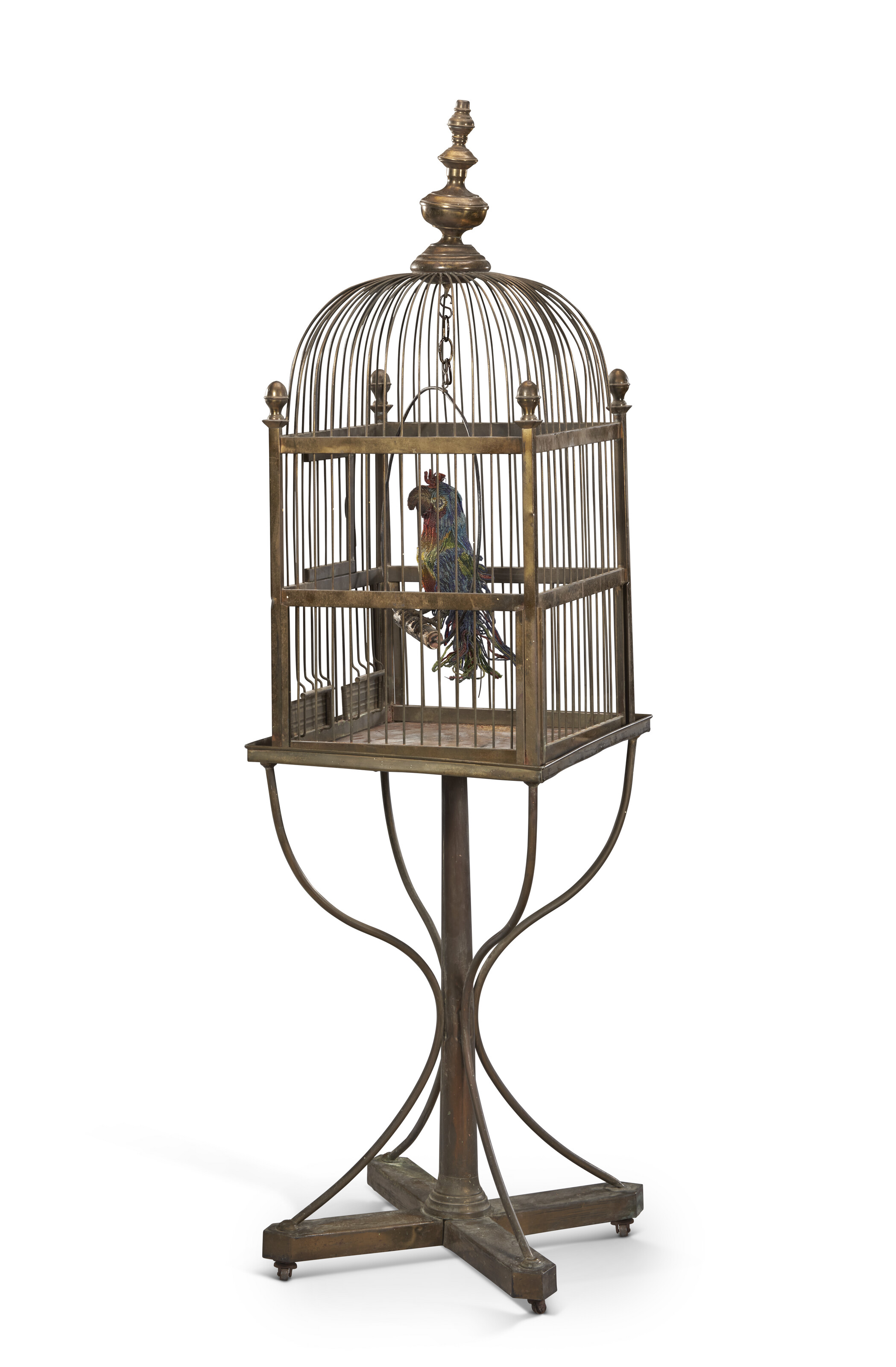 A VICTORIAN BRASS BIRD CAGE ON CONFORMING STAND WITH BEADED MODEL