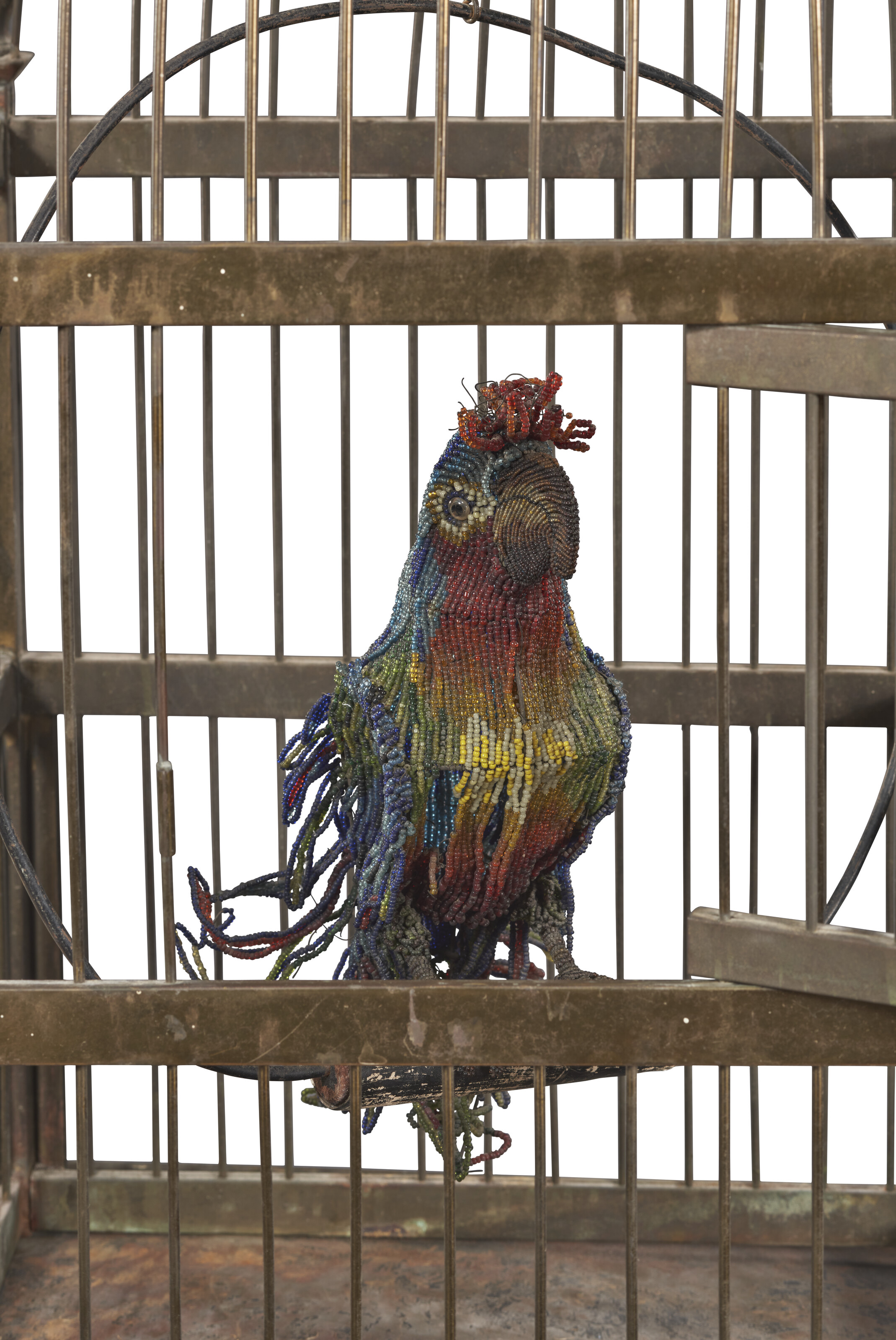 A VICTORIAN BRASS BIRD CAGE ON CONFORMING STAND WITH BEADED MODEL