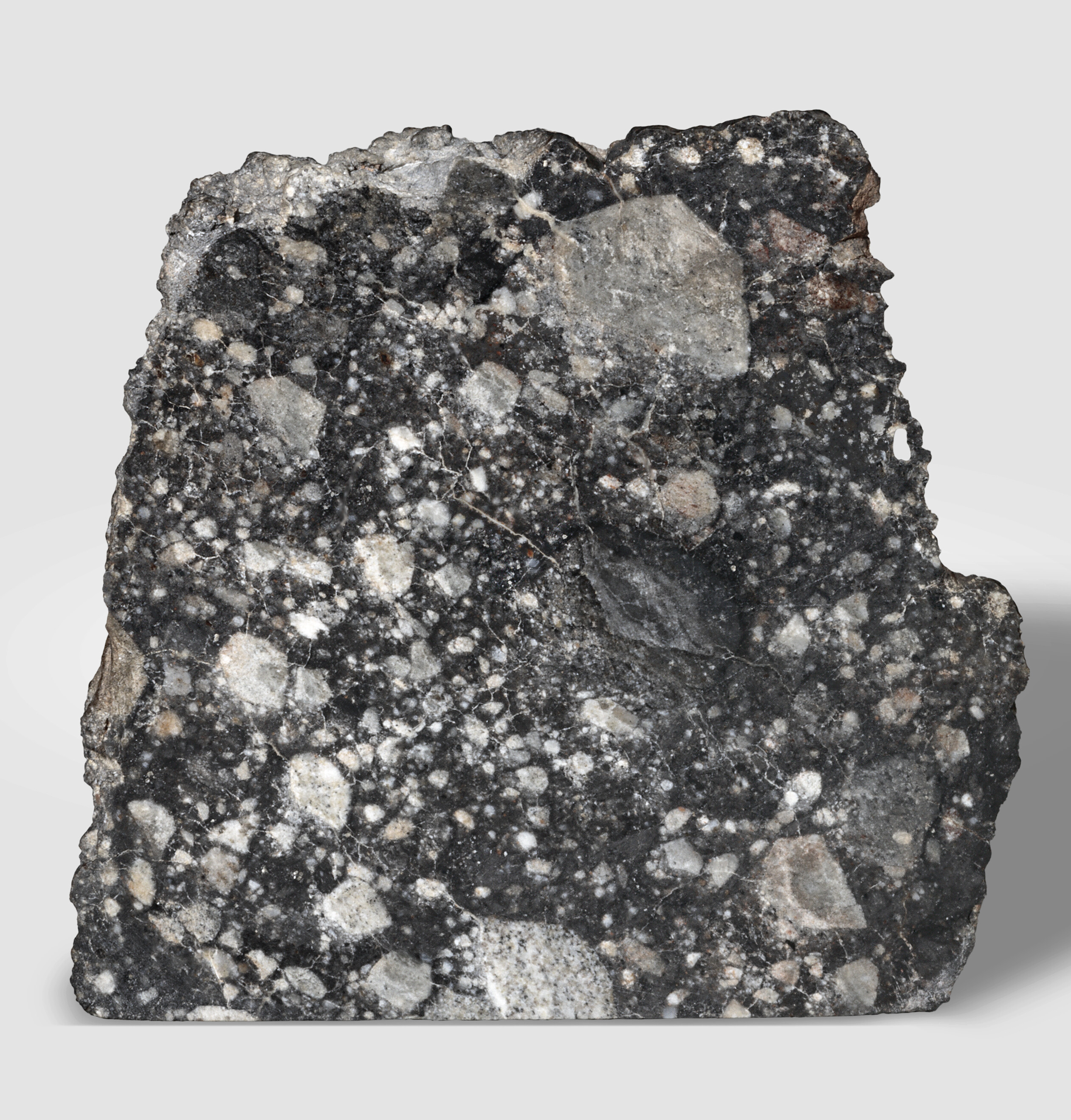 NWA 12691: lunar end piece. The Moon - troctolitic anorthosite; Tubruq, Libya (30.30°N, 24.72°E), offered in Skybreakers: Between Heaven and Earth until 12 December 2025 at Christie's Online