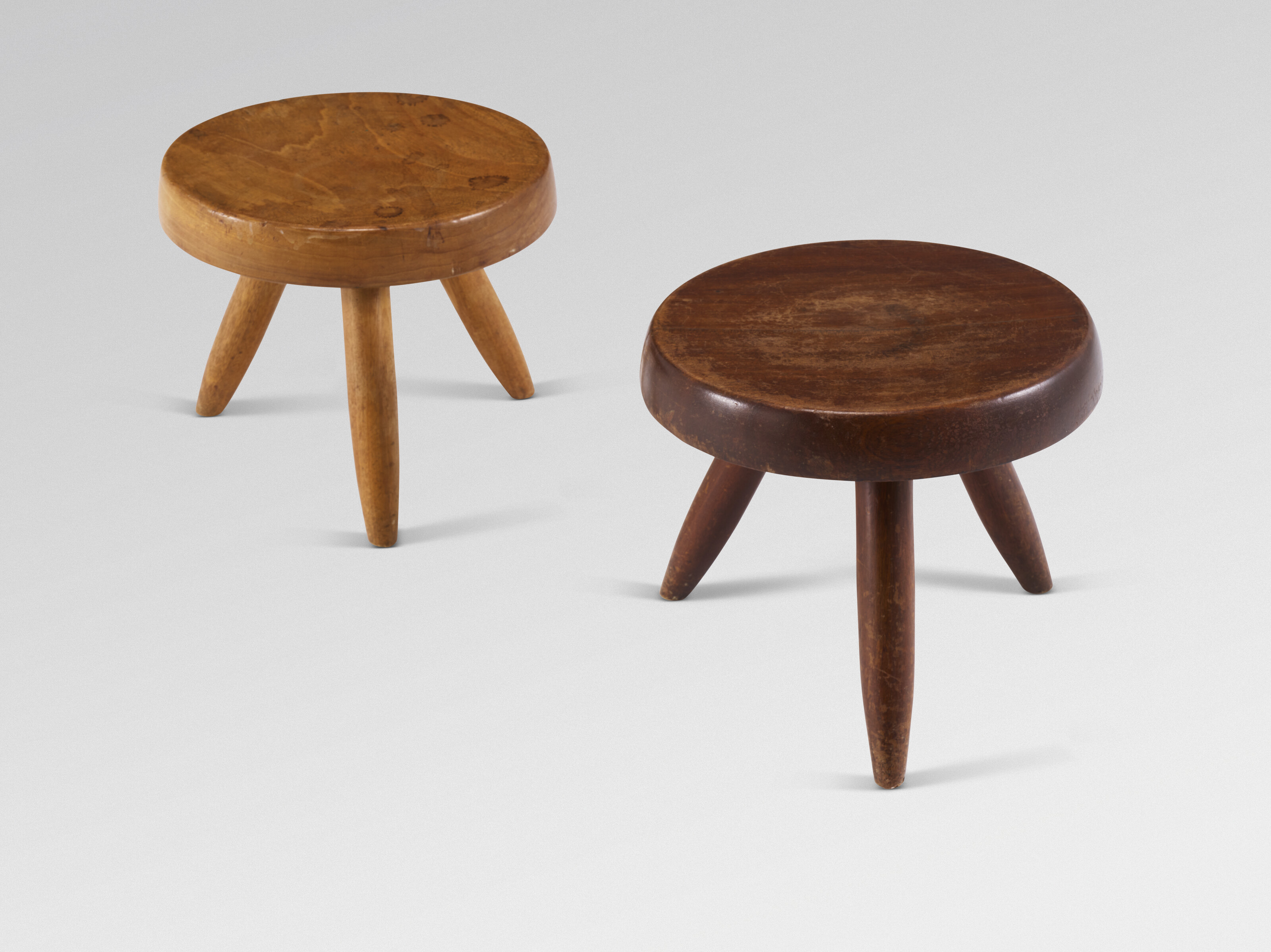 Charlotte Perriand, a pair of Berger tripod stools, 1953, offered in Design on 21 May 2025 at Christie's in Paris