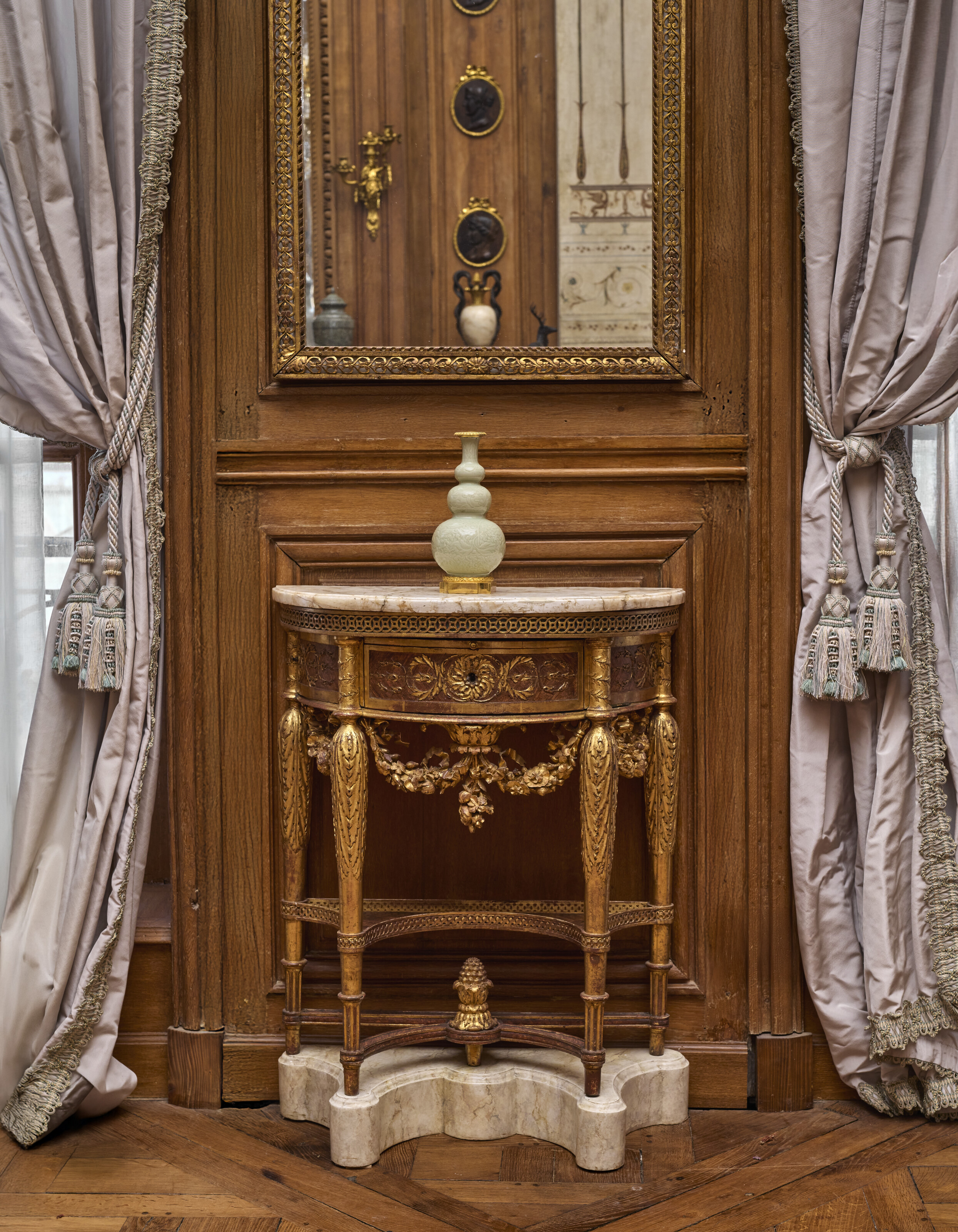 Displayed at Galerie Steinitz, one of a matched pair of Louis XVI painted and giltwood demi-lune consoles, stamped by Jean-Francois Leleu, circa 1780, offered in Madame Simone Steinitz: The Legacy of Taste on 19 June 2025 at Christie's in Paris