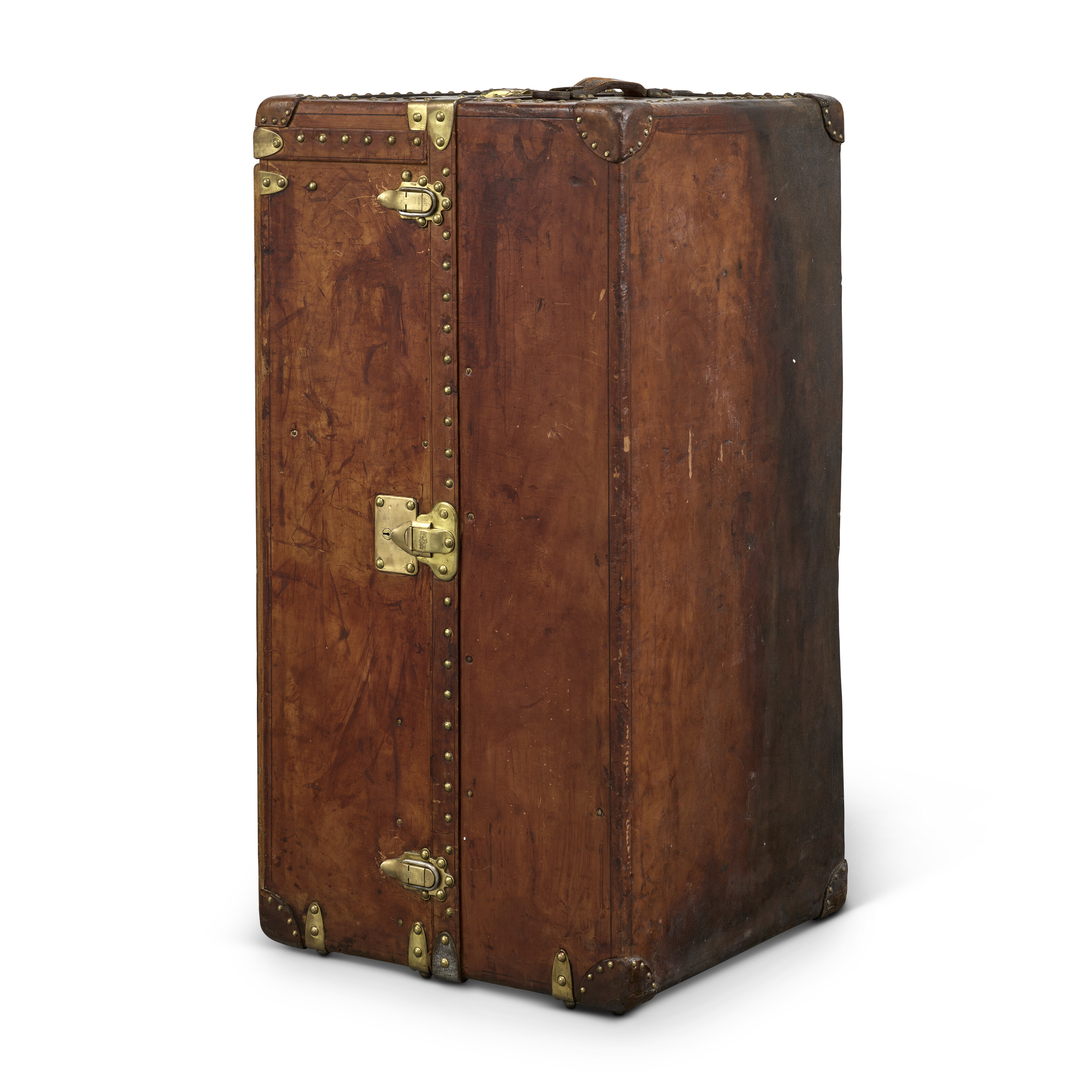 A natural cowhide leather wardrobe trunk with brass hardware, Louis Vuitton, 1946, offered in Legendary Trunks: A European Private Collection Part II, until 1 July 2025 at Christie's Online