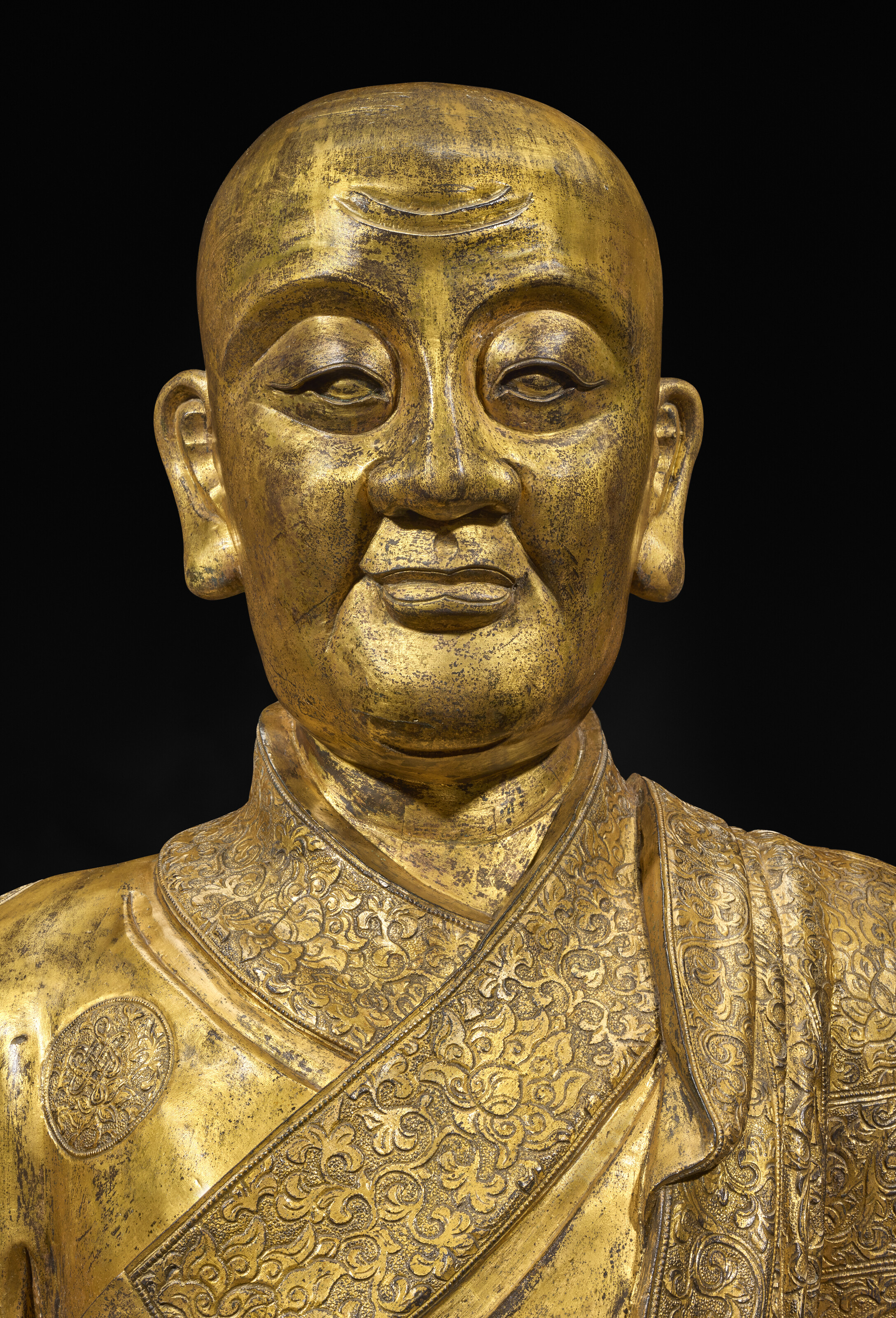 A detail of the 15th-century Ming dynasty imperial gilt-bronze figure of a Karmapa lineage master. Such works were not merely devotional objects, but also potent symbols of religious patronage and political legitimacy. Offered in Art d'Asie on 10 June 2026 at Christie's in Paris