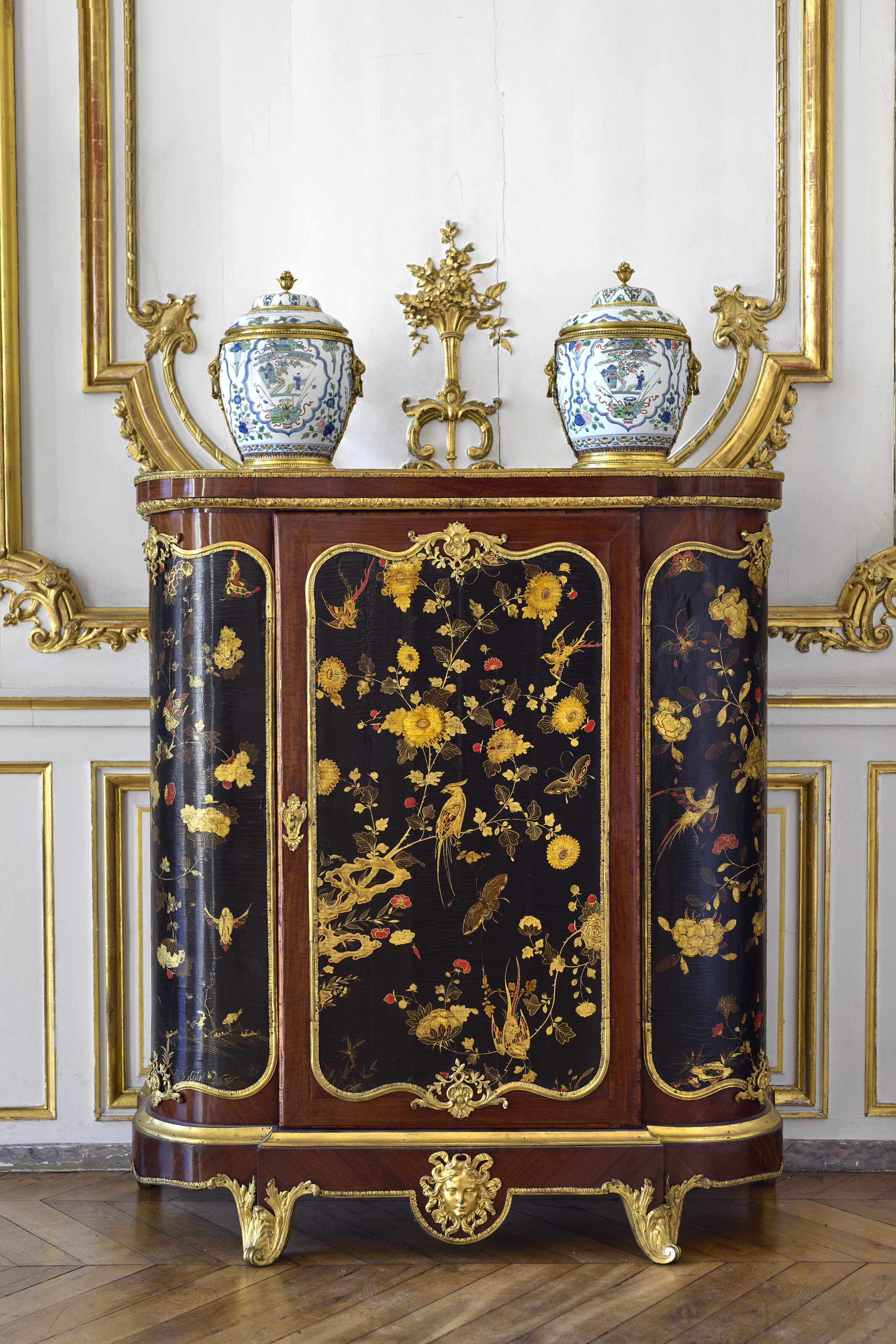 In the grand salon of the Hotel Blumenthal, an early Louis XV ormolu-mounted Chinese lacquer and amaranth cabinet, circa 1735, and a pair of Regence Chinese porcelain vases and covers, circa 1720, both offered in the Graziella Patino de Ortiz Linares Collection - Evening Sale on 23 September 2026 at Christie's in Paris