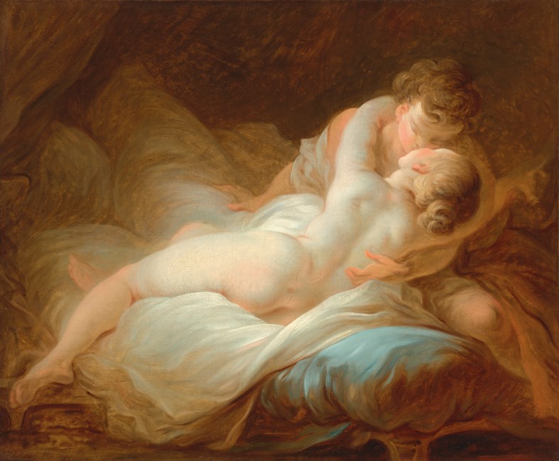 Two lovers embrace on a bed amid pale blue and white sheets and warm brown drapery.
