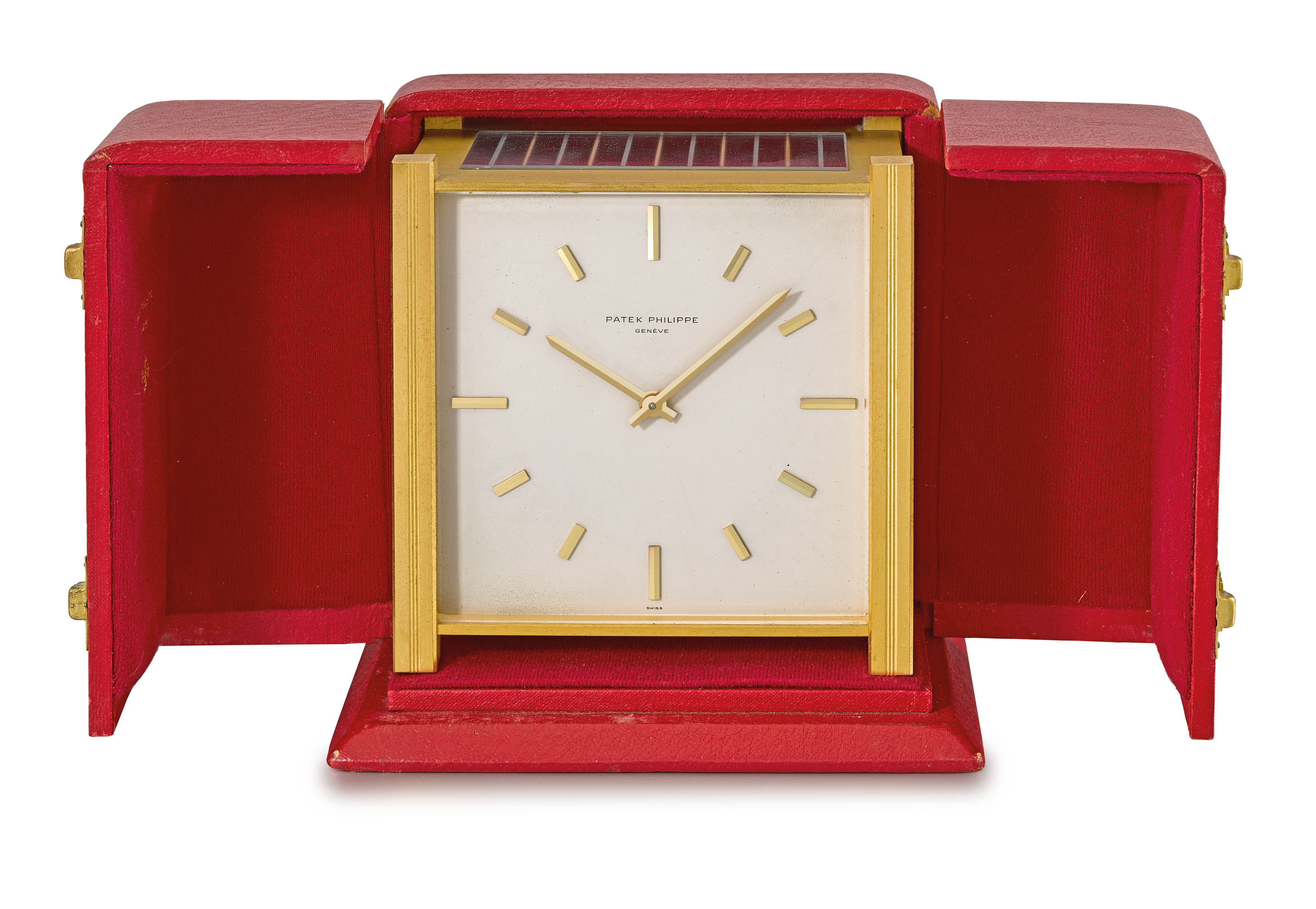 Patek Philippe. A gilt brass squareshaped solarpowered table clock