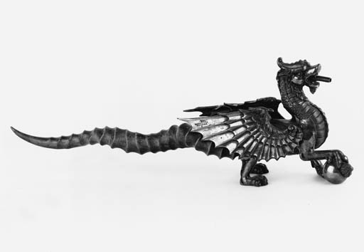 An unusual late Victorian electro-plated novelty cigar lighter
in the form of a dragon with an antelope or buck horn antler tail, by Walker & Hall, Sheffield circa 1900, (lacking taper and having a detachable head) - 43.5cm long.
See Ill