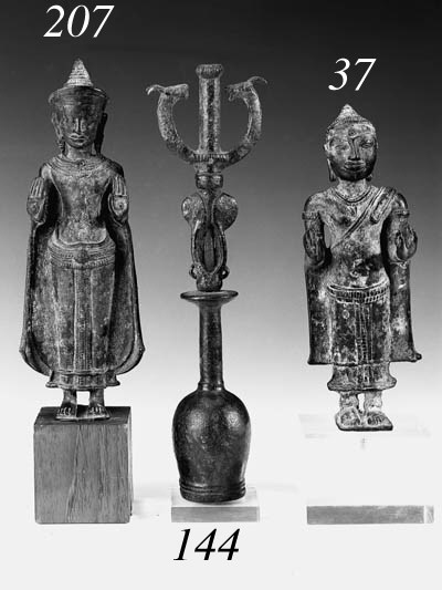 A KHMER BRONZE MODEL OF A STANDING BUDDHA