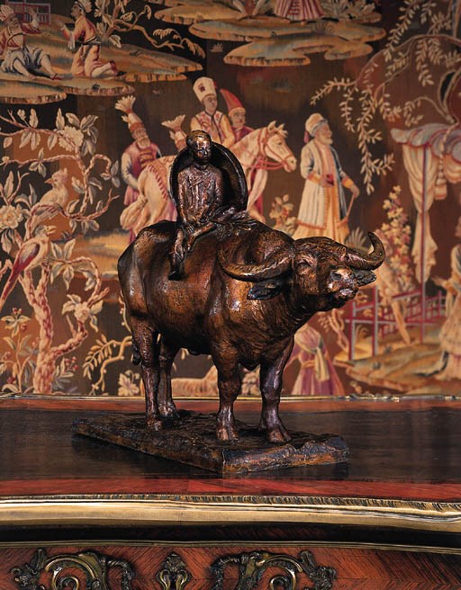 A French bronze group of an oriental boy riding an ox