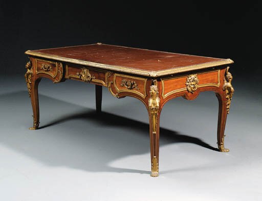 A French ormolu-mounted mahogany and brass-strung bureau plat