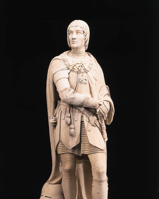 A pair of English Caen stone figures of Lord and Lady Daubeney, on pedestals