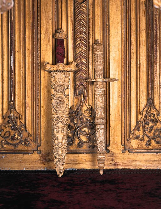 Two carved ivory daggers and sheaths