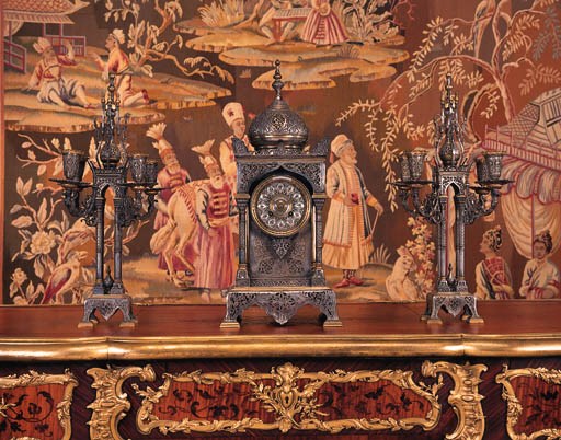 A French silvered and gilt bronze Orientalist clock garniture