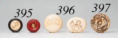 A RED LACQUERED WOOD MANJU NETSUKE AND AN IVORY AND INDONESIAN IRONWOOD MANJU NETSUKE