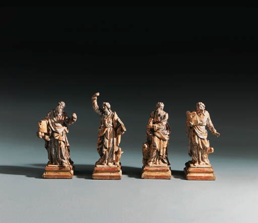 A SET OF FOUR PARCEL-GILT, SILVERED POLYCHROME WOOD FIGURES OF THE EVANGELISTS