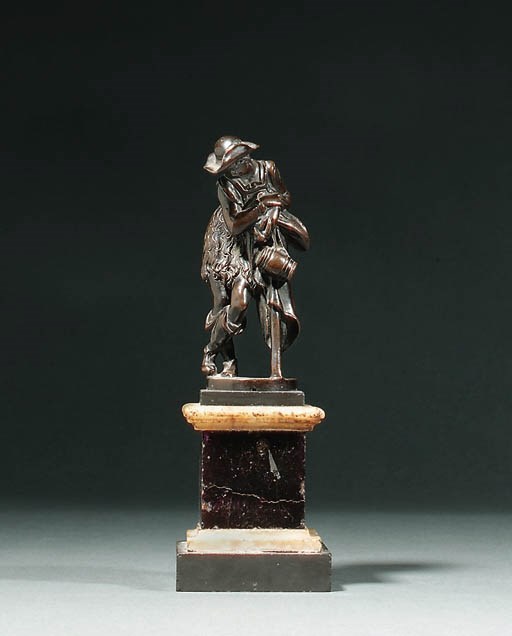A BRONZE FIGURE OF A PEASANT