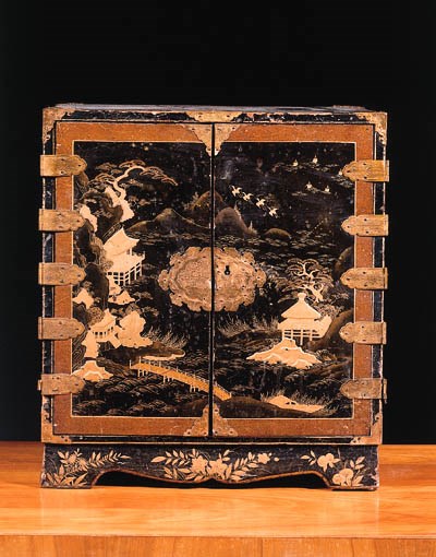 A Japanese brass-mounted, black and gilt-japanned cabinet