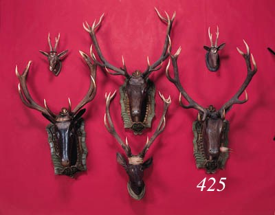 a carved wooden head of a deer