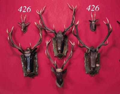 five carved wooden heads of deer