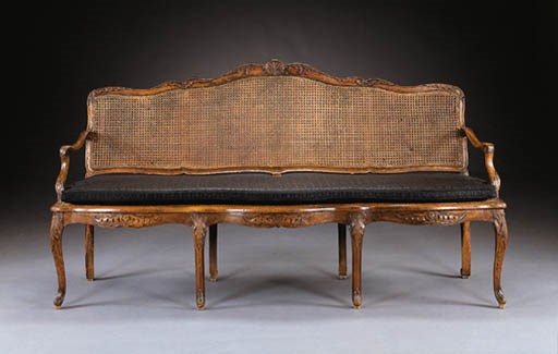 AN EARLY LOUIS XV BEECHWOOD CANAPE