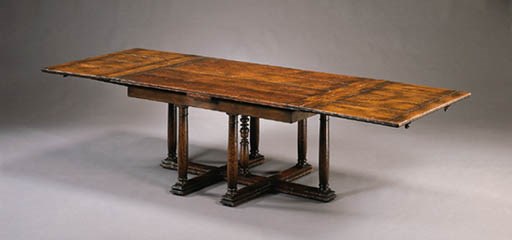 A HENRI II STYLE WALNUT DRAW-LEAF DINING TABLE