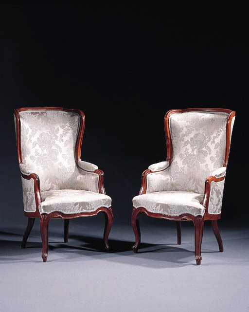 A pair of mahogany wing armchairs