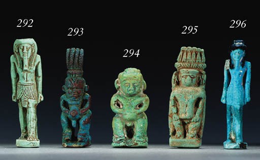 A TURQUOISE GREEN FAIENCE AMULET OF A DEITY