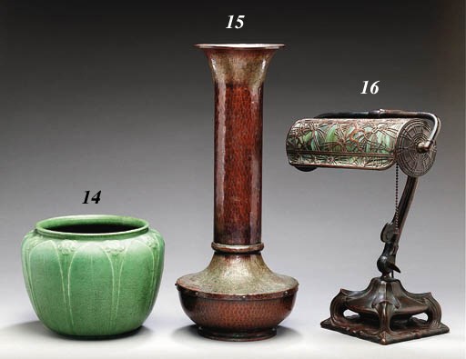A BENT GLASS AND PATINATED-METAL DESK LAMP