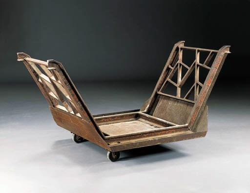A CAST-IRON WOOD TROLLEY