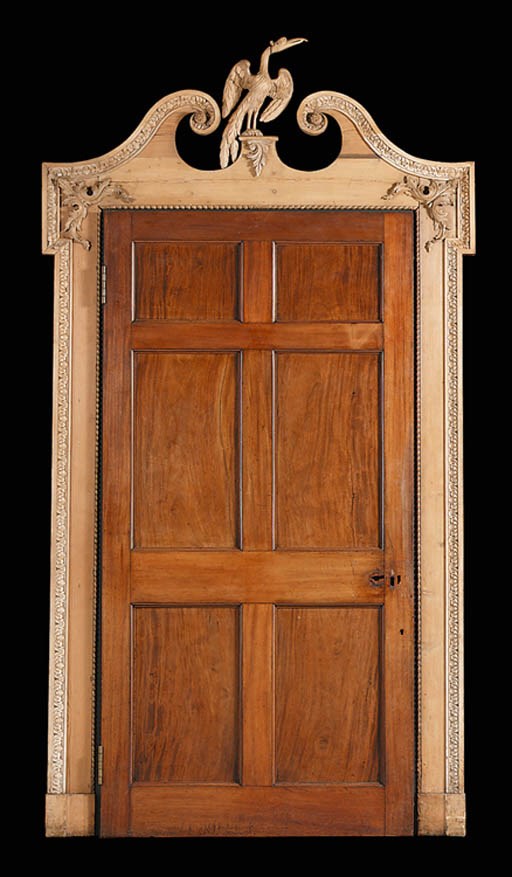 A CARVED PINE DOOR-SURROUND AND A VICTORIAN MAHOGANY DOOR