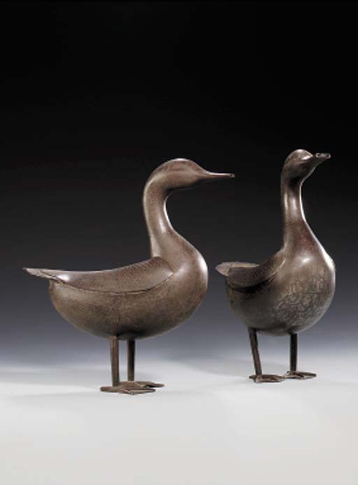 A PAIR OF QAJAR BRASS AND SILVER DAMASCENED STEEL DUCK