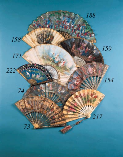 A Canton brise fan, painted with a family at tea on an island and a man and a horse, with a frieze of birds, animals and fish, the verso with three figures with a horse, and a freize of birds and animals, the guardsticks with dragons - 8in. (20cm.), circa 1820