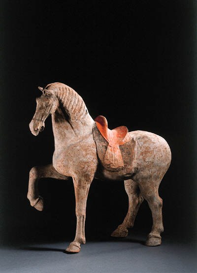 A painted pottery figure of a prancing horse