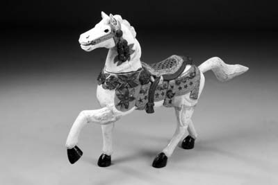 A carved and polychrome decorated model of a horse