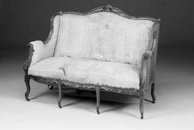 A French carved walnut and upholstered sofa, late 19th century