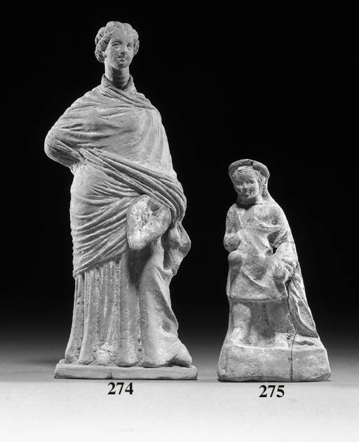 A 'TANAGRA' TERRACOTTA FIGURE OF A YOUNG WOMAN