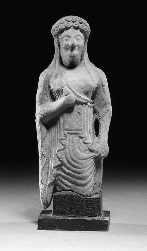 A SICILIAN STANDING TERRACOTTA FEMALE FIGURE