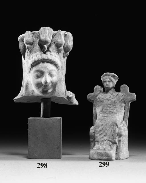 AN ARCHAIC GREEK TERRACOTTA FEMALE HEAD