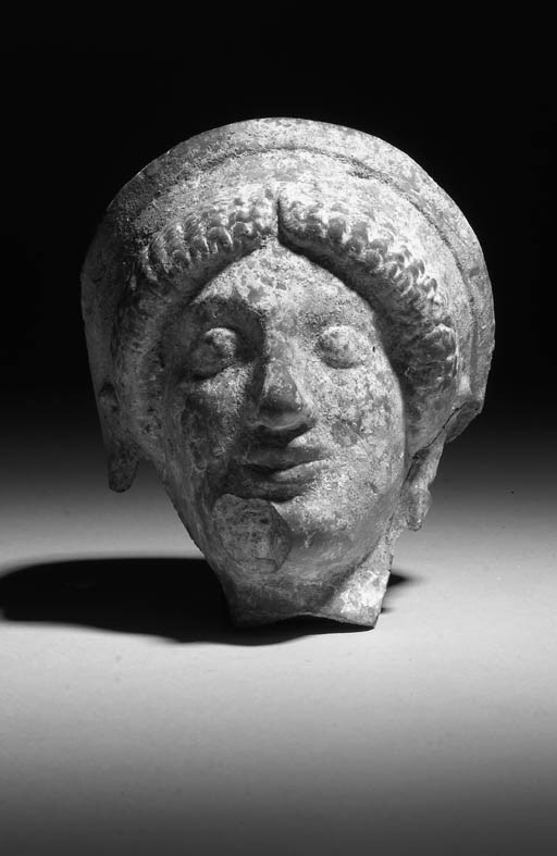 A GREEK TERRACOTTA FEMALE PROTOME