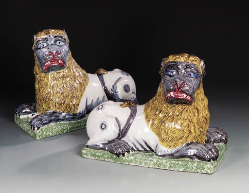A pair of Luneville recumbent lions
