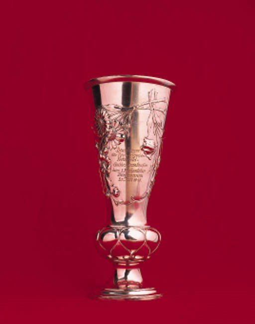 Fritz Held - Hermann Lang; a fine early motoring trophy cup awarded originally to Fritz Held for victory in the Mainz-Coblenz- Mainz Reliability Trial of 1899; this trophy was presented to Hermann Lang in 1946 by Fritz Held, when he offered the trophy as first prize in the newly constituted hill climb event at Ruhestein in July 1946. It is engraved and inscribed on both sides, with original dedication to Held from 1899 and more recently for "Dem Sieger Rennwagen der Fritz Held Gedachtnislaufesheim - 21 Juli 1946." Height 11ins (29cm)