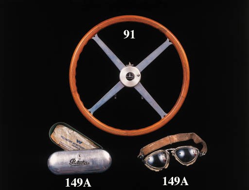 Hermann Lang - an original pair of racing goggles by "Protector", having nickelled brass with adjustable bridge and venting to frames; double curvature laminated lenses, and detatchable elastic strap with nickelled mounts; contained in the polished aluminium case with embossed logo to top, and with original waxed lining to case; rubber cheek protection perished and strap worn.