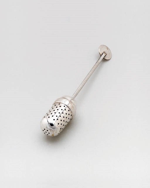 AN ELECTROPLATED BRASS TEA INFUSER