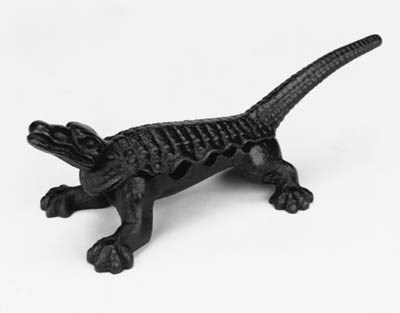 A CAST IRON FOUR DIVISION CROCODILE CORK PRESS.