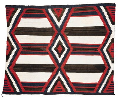 A TRANSITIONAL NAVAJO WEARING BLANKET