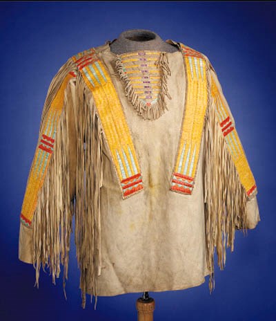A NORTHERN PLAINS QUILLED AND FRINGED HIDE WARRIOR'S SHIRT