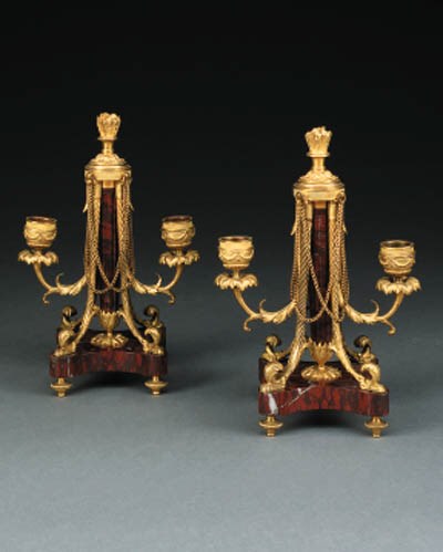 A pair of Napoleon III ormolu and rouge griotte two-light candelabra, circa 187O
